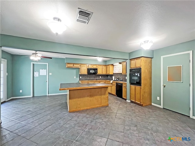 kitchen with tile countertops, black appliances, a textured ceiling, tasteful backsplash, and ceiling fan