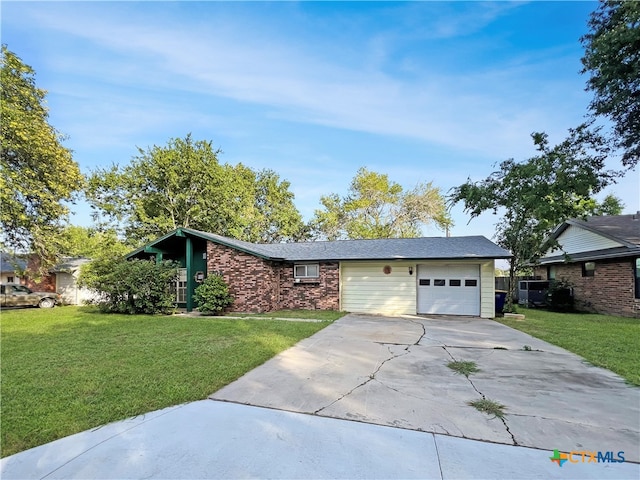 single story home featuring a garage and a front lawn