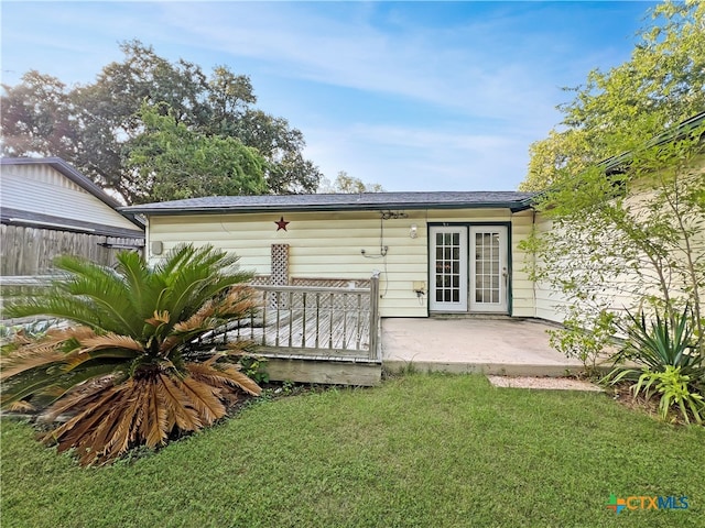 rear view of property featuring a patio area and a yard