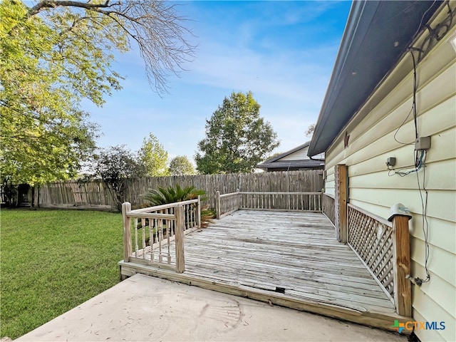 wooden deck featuring a lawn