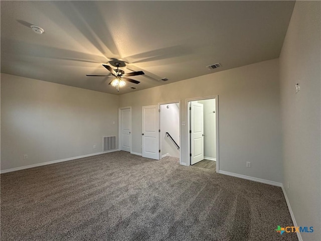 unfurnished bedroom featuring ceiling fan and dark colored carpet