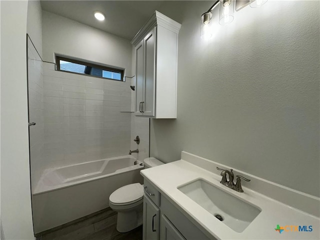 full bathroom featuring toilet, vanity, hardwood / wood-style floors, and shower / washtub combination