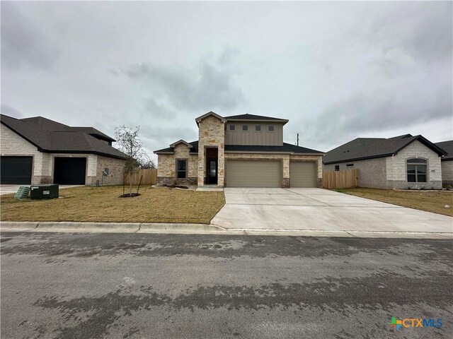 view of front of property with a garage and a front yard