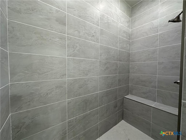 bathroom featuring tiled shower