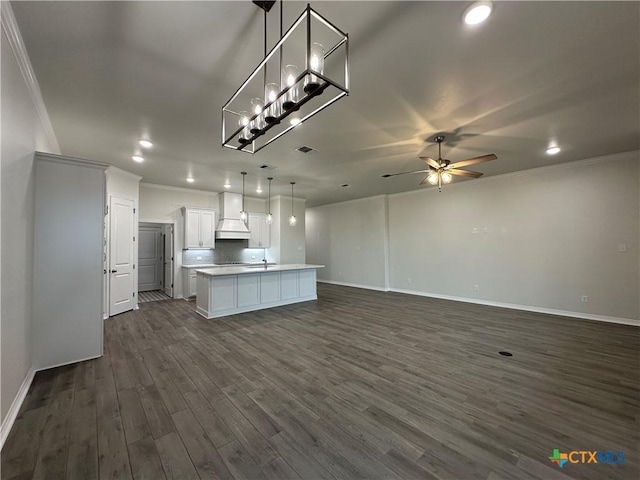 kitchen with dark wood-type flooring, white cabinets, decorative light fixtures, a center island, and custom exhaust hood