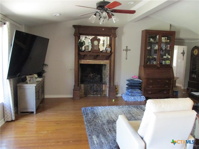3512 Magnolia Blvd, Temple, TX 76502 - living room featuring a ceiling fan, a fireplace, light wood-style flooring, and baseboards