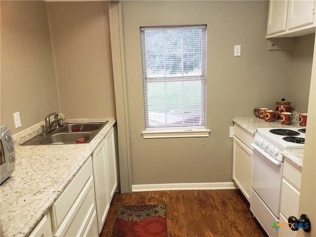 3512 Magnolia Blvd, Temple, TX 76502 - kitchen with white electric stove, a sink, dark wood finished floors, baseboards, and white cabinets