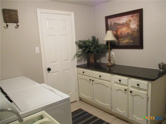 3512 Magnolia Blvd, Temple, TX 76502 - washroom featuring separate washer and dryer, light tile patterned flooring, and cabinet space