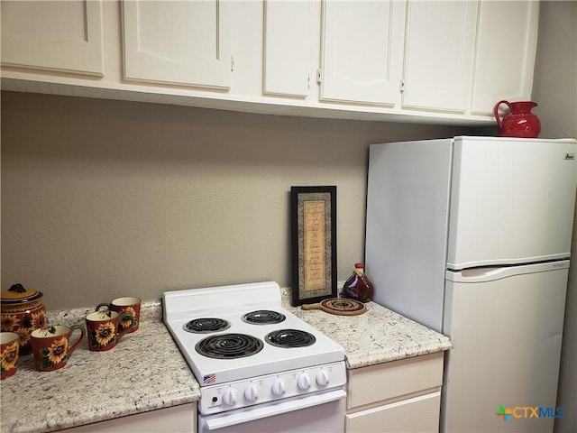 3512 Magnolia Blvd, Temple, TX 76502 - kitchen with white appliances, white cabinets, and light stone counters
