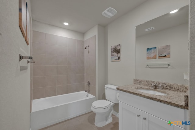 full bathroom with tile patterned floors, vanity, toilet, and tiled shower / bath