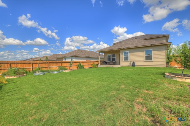 back of property featuring a lawn and a patio