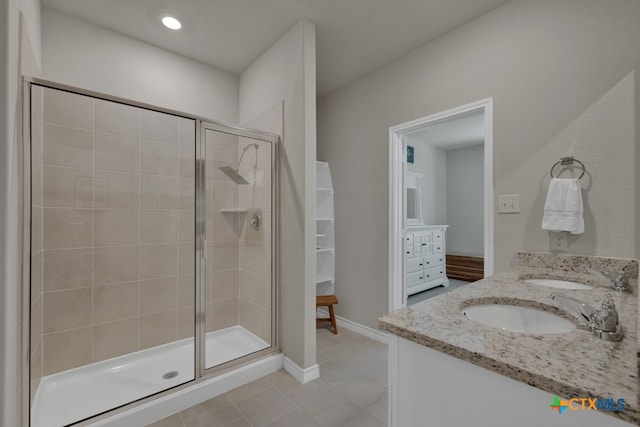 bathroom with tile patterned flooring, vanity, and an enclosed shower