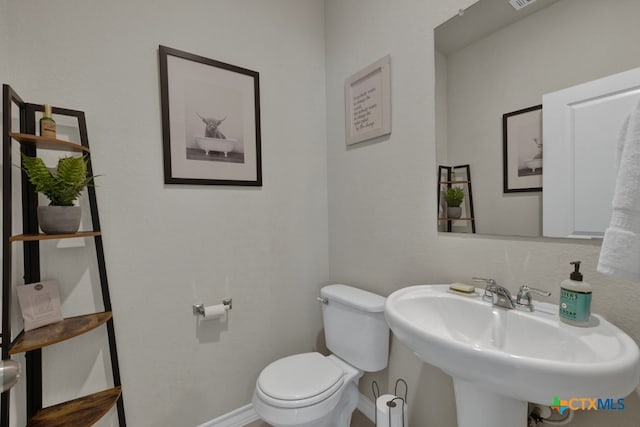 bathroom with toilet and sink