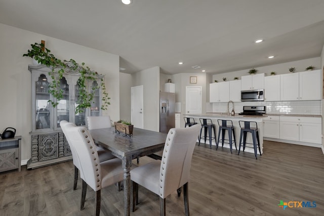 dining space featuring dark hardwood / wood-style flooring and sink