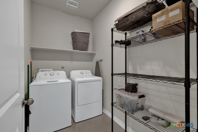 laundry room with washing machine and dryer and light tile patterned flooring