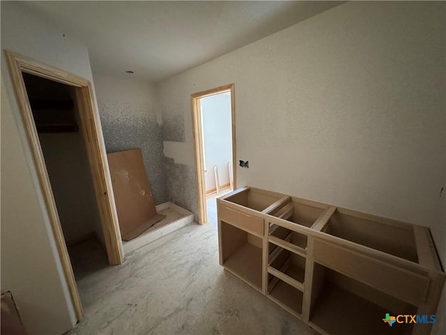 interior space featuring a textured wall