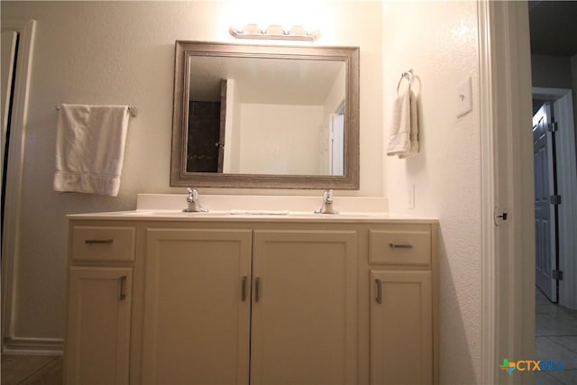 bathroom with tile patterned flooring and vanity