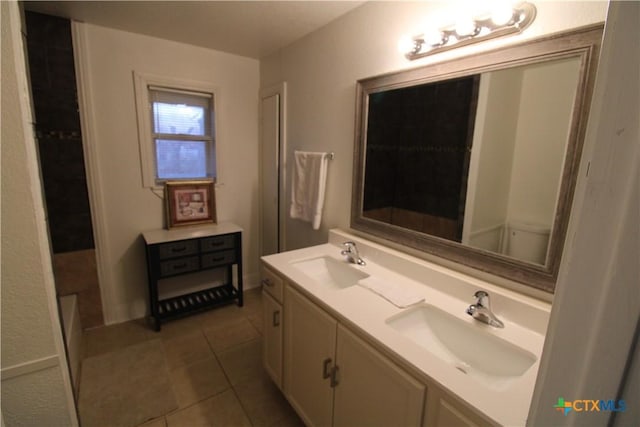 bathroom featuring tile patterned flooring and vanity