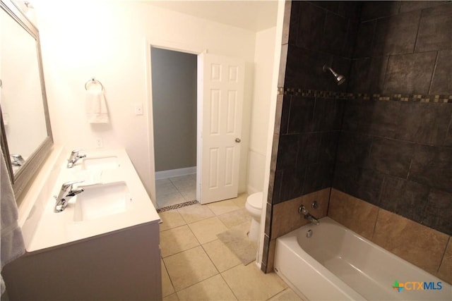 full bathroom featuring tile patterned flooring, vanity, tiled shower / bath combo, and toilet