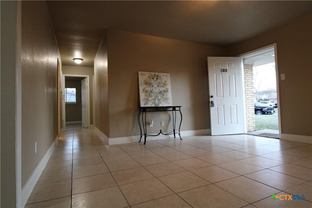 empty room with plenty of natural light and light tile patterned flooring