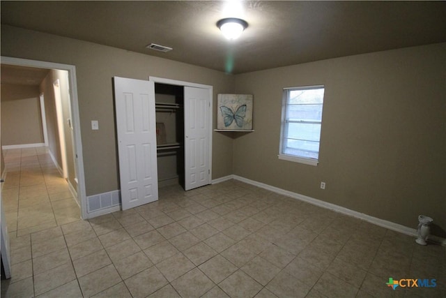 unfurnished bedroom with a closet