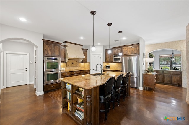 1448 Decanter Dr, New Braunfels, TX 78132 - kitchen featuring arched walkways, appliances with stainless steel finishes, decorative backsplash, and recessed lighting