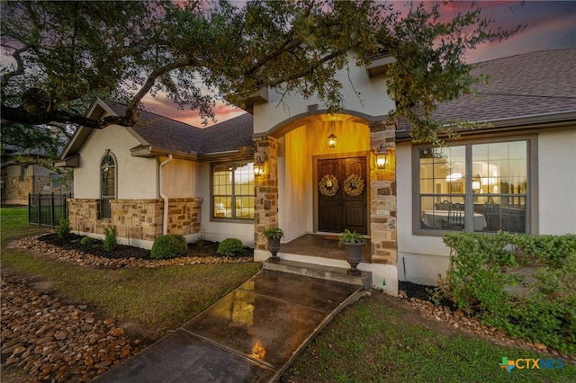 1448 Decanter Dr, New Braunfels, TX 78132 - view of exterior entry with stone siding, stucco siding, and roof with shingles