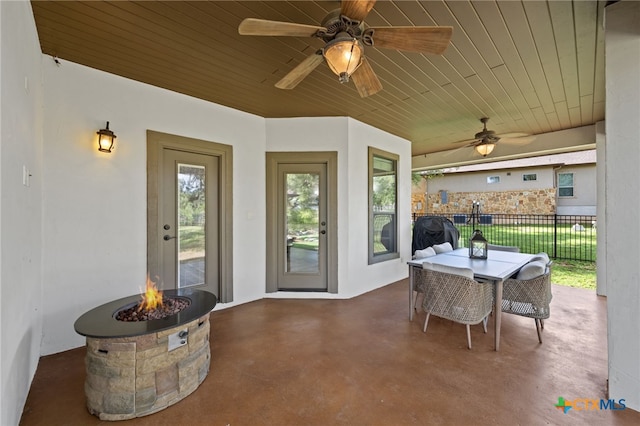1448 Decanter Dr, New Braunfels, TX 78132 - view of patio featuring a fire pit, outdoor dining area, and a ceiling fan