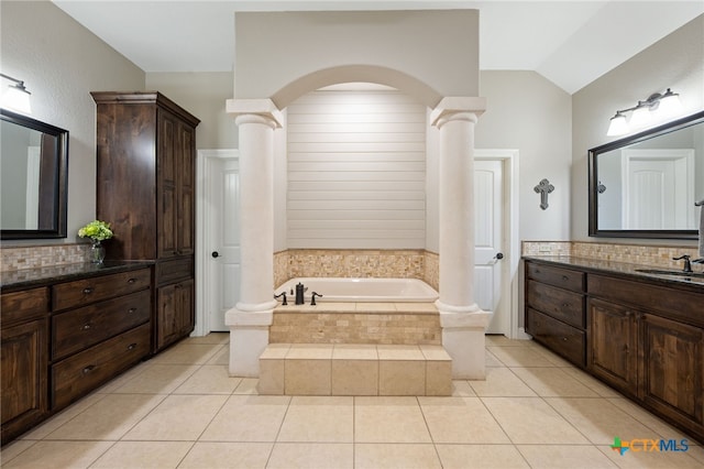 1448 Decanter Dr, New Braunfels, TX 78132 - full bathroom with decorative columns, a bath, tile patterned floors, vanity, and vaulted ceiling