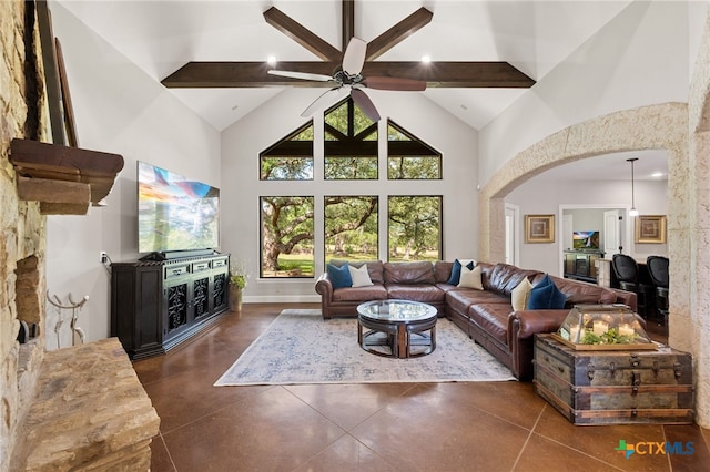 1448 Decanter Dr, New Braunfels, TX 78132 - living room with high vaulted ceiling, a ceiling fan, arched walkways, finished concrete floors, and beam ceiling