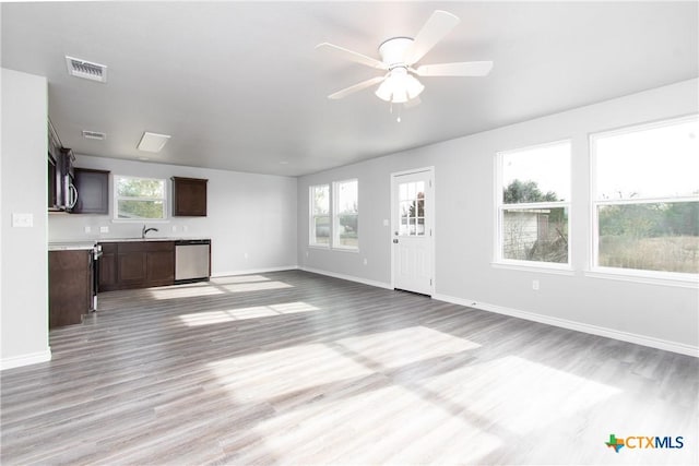 unfurnished living room with ceiling fan, a healthy amount of sunlight, and light hardwood / wood-style floors