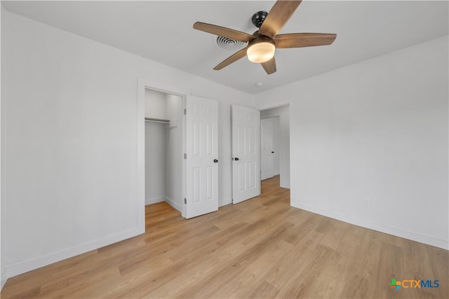 unfurnished bedroom featuring light hardwood / wood-style flooring, ceiling fan, and a closet