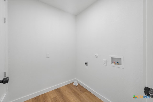 clothes washing area with gas dryer hookup, hardwood / wood-style flooring, hookup for a washing machine, and hookup for an electric dryer