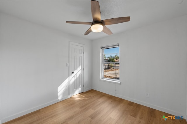 empty room featuring light wood-type flooring and ceiling fan