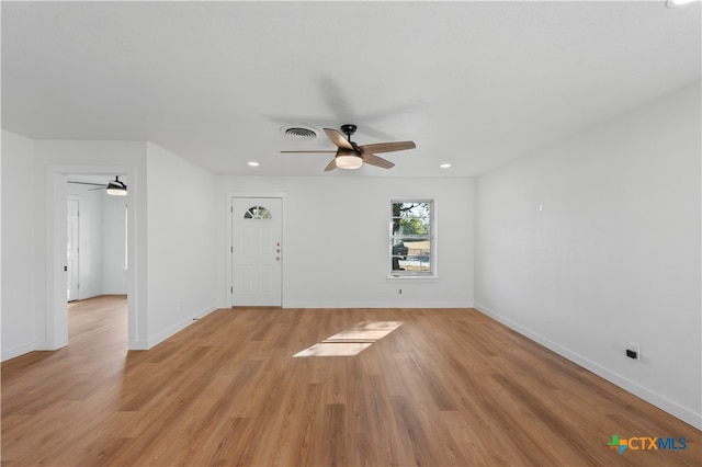 empty room with light hardwood / wood-style floors and ceiling fan