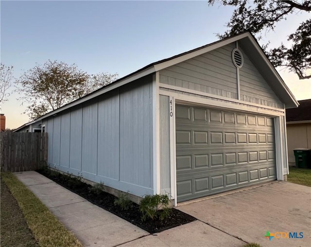 view of garage at dusk