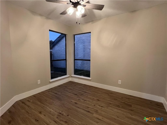 spare room with ceiling fan and dark hardwood / wood-style flooring