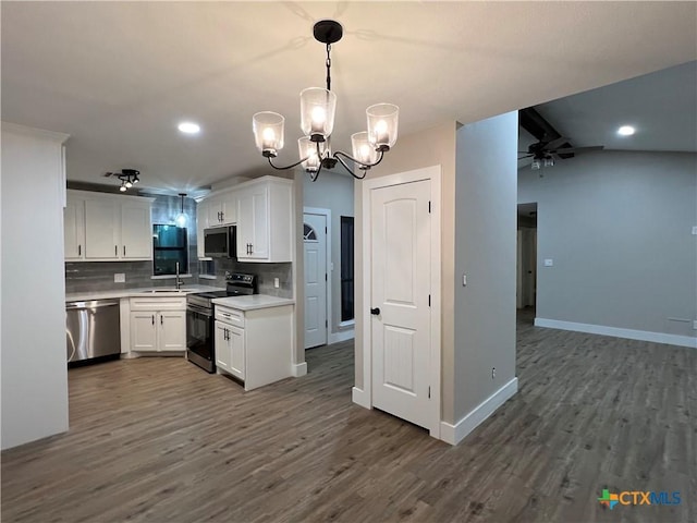 kitchen featuring appliances with stainless steel finishes, dark hardwood / wood-style flooring, tasteful backsplash, ceiling fan with notable chandelier, and white cabinets