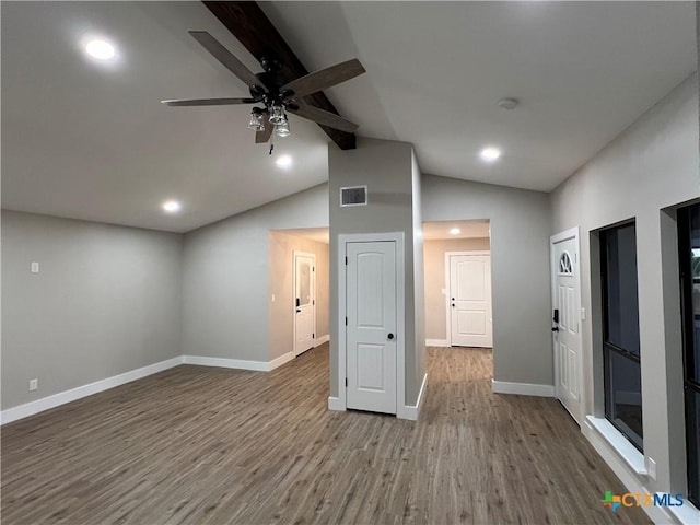 spare room with hardwood / wood-style floors, high vaulted ceiling, and ceiling fan