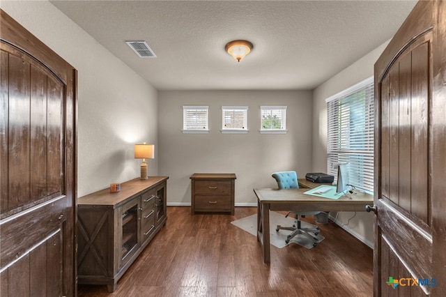 office with a textured ceiling and dark hardwood / wood-style floors