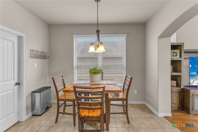 dining room featuring light tile patterned floors and an inviting chandelier