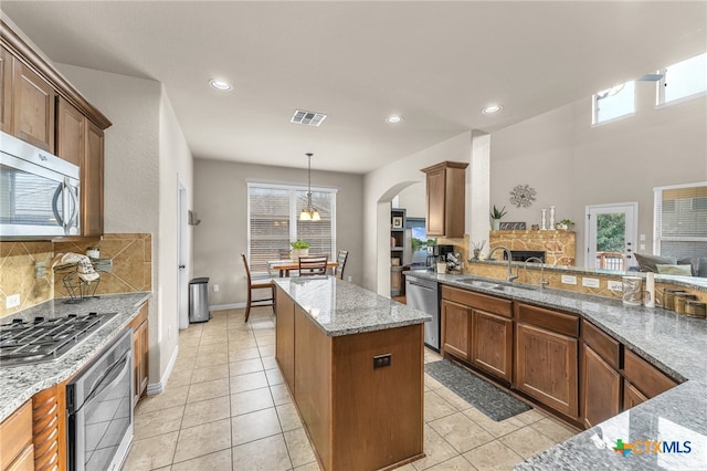 kitchen featuring pendant lighting, appliances with stainless steel finishes, sink, and a healthy amount of sunlight