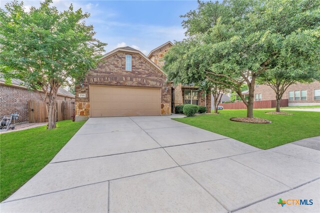 view of front of property featuring a garage and a front yard