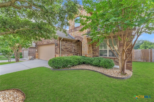 view of front of home with a garage and a front lawn