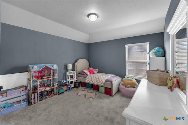 carpeted bedroom with a textured ceiling