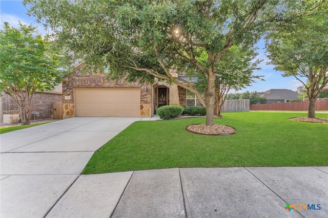 view of front of house featuring a front lawn and a garage