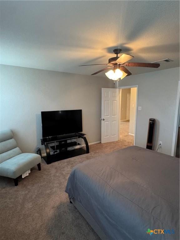 carpeted bedroom featuring visible vents and a ceiling fan