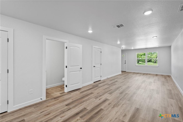 614 S 24th St, Temple, TX 76501 - unfurnished room with light wood-style floors, baseboards, recessed lighting, and a textured ceiling