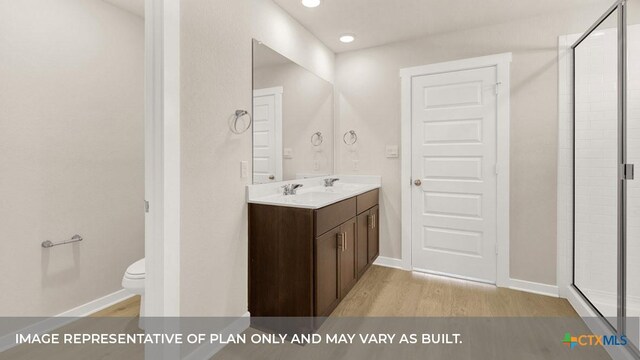 193 Zane Saddle Rd, Lockhart, TX 78644 - bathroom with a shower stall, toilet, wood finished floors, and vanity