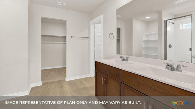 193 Zane Saddle Rd, Lockhart, TX 78644 - bathroom with visible vents, a sink, a spacious closet, and a shower stall